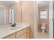 Bright bathroom featuring a sink vanity, mirror, and toilet at 1439 Mill Pointe Ct, Lawrenceville, GA 30043