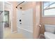 Bathroom with white bathtub and black shower fixtures, alongside a toilet and tiled floors at 1439 Mill Pointe Ct, Lawrenceville, GA 30043