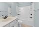 Well-lit bathroom features a shower-tub combo with tiled walls and modern fixtures at 1439 Mill Pointe Ct, Lawrenceville, GA 30043