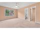 Spacious bedroom with ceiling fan, window, and access to bathroom and closet at 1439 Mill Pointe Ct, Lawrenceville, GA 30043