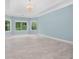 Bright bedroom with large windows, tray ceiling, and light blue walls at 1439 Mill Pointe Ct, Lawrenceville, GA 30043