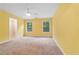 Comfortable bedroom featuring two windows, a ceiling fan and connecting door at 1439 Mill Pointe Ct, Lawrenceville, GA 30043
