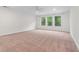 Bright bedroom with large windows, neutral walls, and cozy carpeting at 1439 Mill Pointe Ct, Lawrenceville, GA 30043