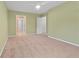 Bright bedroom with neutral carpet, green walls, ceiling fan and multiple doorways at 1439 Mill Pointe Ct, Lawrenceville, GA 30043