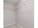 A walk-in closet with wire shelving, ready to be organized for optimal storage at 1439 Mill Pointe Ct, Lawrenceville, GA 30043