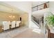 Open-concept dining room featuring stylish wallpaper and views of the staircase and upper level at 1439 Mill Pointe Ct, Lawrenceville, GA 30043