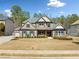 Two-story brick home featuring blue shutters, a well-manicured lawn, and an attached garage at 1439 Mill Pointe Ct, Lawrenceville, GA 30043