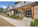 Inviting front porch with stone and brick accents, decorative door, and manicured landscaping at 1439 Mill Pointe Ct, Lawrenceville, GA 30043