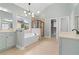 Luxurious main bathroom with separate vanities, soaking tub, and glass shower at 1439 Mill Pointe Ct, Lawrenceville, GA 30043