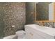 Stylish powder room featuring designer wallpaper and elegant gold fixtures at 1439 Mill Pointe Ct, Lawrenceville, GA 30043