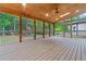 The screened porch offers outdoor living with a ceiling fan and views of the private backyard at 1439 Mill Pointe Ct, Lawrenceville, GA 30043