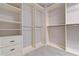 Spacious walk-in closet with custom shelving, drawers, and hanging rods at 1439 Mill Pointe Ct, Lawrenceville, GA 30043