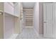 Organized walk-in closet featuring custom shelving, drawers, and door to entry at 1439 Mill Pointe Ct, Lawrenceville, GA 30043