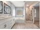 Elegant bathroom with a white vanity, soaking tub, and separate shower at 1851 Millwood Park Ct, Buford, GA 30518