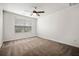 Cozy bedroom with neutral walls, plush carpet, and a ceiling fan at 1851 Millwood Park Ct, Buford, GA 30518