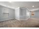 Carpeted primary bedroom featuring a large window and neutral color scheme at 1851 Millwood Park Ct, Buford, GA 30518