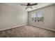 Comfortable bedroom with neutral carpet, a ceiling fan and a window with blinds at 1851 Millwood Park Ct, Buford, GA 30518