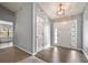 Bright foyer with hardwood floors, vaulted ceiling, and a front door with sidelights and transom window at 1851 Millwood Park Ct, Buford, GA 30518