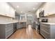 Stylish kitchen featuring stainless steel appliances, ample cabinet space, and views into the living area at 1851 Millwood Park Ct, Buford, GA 30518