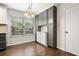 Bright kitchen nook with window, wood floors, and gray storage cabinets at 1851 Millwood Park Ct, Buford, GA 30518