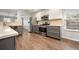 Updated kitchen boasts stainless steel appliances, gray cabinets, and seamless flow into the living spaces at 1851 Millwood Park Ct, Buford, GA 30518