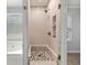 Tiled walk-in shower with a glass door in a modern bathroom at 1851 Millwood Park Ct, Buford, GA 30518