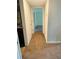 Hallway leads to carpeted bedrooms, with a glimpse of the kitchen at 2958 Parc Lorraine, Lithonia, GA 30038