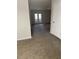 Spacious living room featuring neutral carpeting and double doors to outdoors at 2958 Parc Lorraine, Lithonia, GA 30038