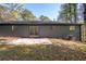 Backyard featuring a small patio, green grass and a mix of deciduous and evergreen trees at 5726 Southwick Sw Ct, College Park, GA 30349
