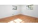 An empty bedroom with hardwood floors and a view of the tree canopy outside the windows at 5726 Southwick Sw Ct, College Park, GA 30349