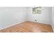 Bedroom featuring hardwood floors, a window, and closet at 5726 Southwick Sw Ct, College Park, GA 30349