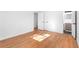 An empty bedroom with hardwood floors showing the door to the en suite bathroom at 5726 Southwick Sw Ct, College Park, GA 30349