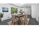 Stylish dining area with a wooden table, comfortable chairs, stainless steel appliances, and lots of natural light at 5726 Southwick Sw Ct, College Park, GA 30349
