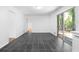 Open dining area with gray tile flooring and sliding door to backyard at 5726 Southwick Sw Ct, College Park, GA 30349