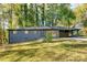 Charming single-story home with a painted brick facade, mature trees, and a welcoming covered carport at 5726 Southwick Sw Ct, College Park, GA 30349