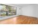 Bright living room with hardwood floors, a large window, and a white front door at 5726 Southwick Sw Ct, College Park, GA 30349