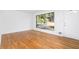 Bright living room featuring hardwood floors and a large window with natural light at 5726 Southwick Sw Ct, College Park, GA 30349