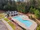 A community pool area with lounge chairs, a clubhouse, and mature trees offers a relaxing outdoor space at 108 Summer Breeze Ln, Canton, GA 30114