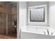 Bathroom featuring a soaking tub, tiled shower with glass doors, and large window at 108 Summer Breeze Ln, Canton, GA 30114