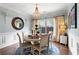 Bright dining room with wood floors, elegant chandelier, and a round table for intimate gatherings at 108 Summer Breeze Ln, Canton, GA 30114