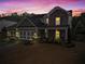 Charming two-story home with a mix of stone and siding, a well-manicured lawn, and a three car garage at 108 Summer Breeze Ln, Canton, GA 30114