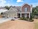 Charming two-story home featuring stone accents, a well-manicured lawn, and a three-car garage at 108 Summer Breeze Ln, Canton, GA 30114
