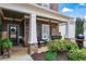 Inviting covered front porch with stone accents, rocking chairs, and a decorative front door wreath at 108 Summer Breeze Ln, Canton, GA 30114