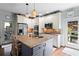 Well-lit kitchen with stainless steel appliances, granite counters, and open access to the outdoor patio at 108 Summer Breeze Ln, Canton, GA 30114