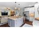 Open kitchen featuring a gray island with granite countertops, stainless steel appliances, and hardwood floors at 108 Summer Breeze Ln, Canton, GA 30114