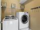 Convenient laundry room with washer, dryer, and wire shelving for storage and organization at 108 Summer Breeze Ln, Canton, GA 30114