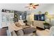 Comfortable living room with a large sofa, decorative cabinets, and an open view of the staircase at 108 Summer Breeze Ln, Canton, GA 30114