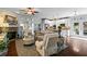Bright open living room with hardwood floors, fireplace, and seamless connection to a modern kitchen at 108 Summer Breeze Ln, Canton, GA 30114