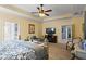 Bright primary bedroom with neutral carpeting, tray ceiling, and ample sitting and dresser space at 108 Summer Breeze Ln, Canton, GA 30114