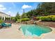 Scenic backyard pool featuring stone accents and waterfall features with a lush green backdrop at 108 Summer Breeze Ln, Canton, GA 30114